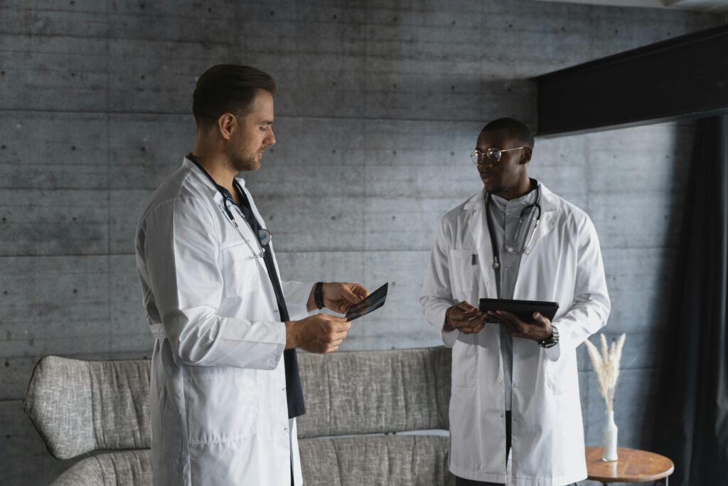 Two doctors in a medical office discussing an x-ray, emphasizing teamwork and healthcare expertise.